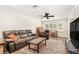 Cozy living room featuring plush gray sofas, stylish rug, and a bright window with shutters at 3024 Saratoga Dr, Orlando, FL 32806