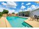 Swimming pool in backyard, surrounded by lounge chairs and screened lanai with patio seating at 3024 Saratoga Dr, Orlando, FL 32806