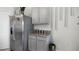 View of a stainless steel refrigerator and gray cabinets with granite countertops at 3081 Viceroy Ct, Poinciana, FL 34759