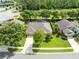Beautiful aerial view of a home featuring a screened-in pool, mature landscaping, and a serene backyard at 315 Belhaven Falls Dr, Ocoee, FL 34761