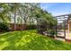 Spacious backyard with a screened-in pool and spa, surrounded by green lawn and privacy landscaping at 315 Belhaven Falls Dr, Ocoee, FL 34761