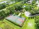 Overhead image of a community basketball court area with trees and nearby homes at 315 Belhaven Falls Dr, Ocoee, FL 34761