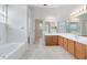 Spacious bathroom featuring tile floors, dual sinks, shower/tub combo, and walk-in closet at 315 Belhaven Falls Dr, Ocoee, FL 34761