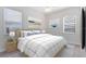 Bright bedroom featuring a queen-sized bed with blue and white linens, and artwork at 315 Belhaven Falls Dr, Ocoee, FL 34761
