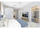 Relaxing primary bedroom with backyard access, TV, and a view into the bathroom at 315 Belhaven Falls Dr, Ocoee, FL 34761