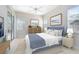 Comfortable primary bedroom features a ceiling fan, light blue accents, and backyard access at 315 Belhaven Falls Dr, Ocoee, FL 34761