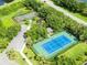 Aerial shot of community sports facilities, including tennis and basketball courts and a playground at 315 Belhaven Falls Dr, Ocoee, FL 34761