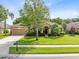 Attractive home with a lush green lawn, mature shade tree, and a welcoming front entrance at 315 Belhaven Falls Dr, Ocoee, FL 34761