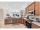 Well-lit kitchen with stainless steel appliances and tile flooring that flows into the living space at 315 Belhaven Falls Dr, Ocoee, FL 34761