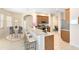 Bright kitchen with breakfast bar, stainless steel appliances, and open layout leading to dining area at 315 Belhaven Falls Dr, Ocoee, FL 34761