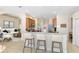 Open-concept kitchen featuring a bar area with seating, adjacent to a cozy living room at 315 Belhaven Falls Dr, Ocoee, FL 34761