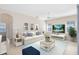 Bright living room features a ceiling fan, TV, nautical decorations, and stylish furniture at 315 Belhaven Falls Dr, Ocoee, FL 34761
