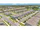 Expansive aerial view of a well-maintained townhome community with lake views at 3303 Azolla St, Orlando, FL 32808