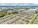 An aerial perspective captures a townhome community, nearby businesses, and a tranquil lake at 3303 Azolla St, Orlando, FL 32808