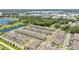 Wide aerial shot showcasing a large townhome community near a pond and greenery at 3303 Azolla St, Orlando, FL 32808