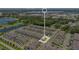 Aerial view highlighting a specific townhome location within a residential community near a pond and foliage at 3303 Azolla St, Orlando, FL 32808