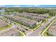 Aerial view of a meticulously planned townhome community with a pond and lush green spaces at 3303 Azolla St, Orlando, FL 32808