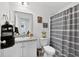 Bathroom featuring a shower with patterned curtain, neutral countertops, and a large mirror at 3303 Azolla St, Orlando, FL 32808