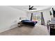 Comfortable bedroom with a ceiling fan, large window, plush carpeting, and furniture at 3303 Azolla St, Orlando, FL 32808