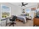 Bright bedroom with large window, desk, ceiling fan, and a comfortable bed with stylish bedding at 3303 Azolla St, Orlando, FL 32808