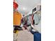 Walk-in closet featuring a variety of clothing, storage shelves, and overhead rack at 3303 Azolla St, Orlando, FL 32808