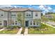 Charming two-story townhome featuring a landscaped yard and inviting front entrance at 3303 Azolla St, Orlando, FL 32808