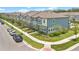 View of townhomes with well-manicured lawns on a sunny day in a suburban neighborhood at 3303 Azolla St, Orlando, FL 32808