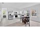 Bright kitchen featuring white cabinets, stainless steel appliances, and a cozy dining area at 3303 Azolla St, Orlando, FL 32808