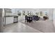 Kitchen flows into living area featuring stainless steel appliances, white cabinetry, and bright windows at 3303 Azolla St, Orlando, FL 32808