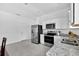 Well-lit kitchen with stainless appliances, granite countertops, and stylish white cabinetry at 3303 Azolla St, Orlando, FL 32808