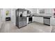 Kitchen features stainless steel appliances, granite countertops, and white cabinets at 3303 Azolla St, Orlando, FL 32808