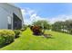 Lush green lawn, pond, and landscaping enhance the home's appeal at 3419 Fernwood Dr, Kissimmee, FL 34741