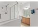 Well-lit bathroom with white tiles and a glass shower at 3419 Fernwood Dr, Kissimmee, FL 34741