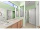 Bathroom features a double sink vanity, a stained glass window, and a walk in shower and toilet at 3419 Fernwood Dr, Kissimmee, FL 34741