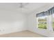 Bright bedroom featuring a large window with garden views at 3419 Fernwood Dr, Kissimmee, FL 34741