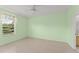 A bright, airy bedroom featuring neutral tile floors, a ceiling fan, and large window with a view at 3419 Fernwood Dr, Kissimmee, FL 34741