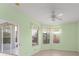 Bright bedroom featuring multiple windows with garden views and a sliding door to the screened lanai at 3419 Fernwood Dr, Kissimmee, FL 34741