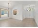 Open dining area with tile flooring, chandelier, window and kitchen view at 3419 Fernwood Dr, Kissimmee, FL 34741