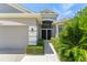 Charming front entrance with a walkway, manicured bushes, and a gray exterior at 3419 Fernwood Dr, Kissimmee, FL 34741