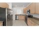 Bright kitchen with stainless steel appliances and wooden cabinetry at 3419 Fernwood Dr, Kissimmee, FL 34741