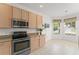 Well-lit kitchen with stainless steel appliances and tile flooring at 3419 Fernwood Dr, Kissimmee, FL 34741