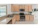 Spacious kitchen with stainless steel appliances and light wood cabinets at 3419 Fernwood Dr, Kissimmee, FL 34741