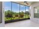 The screened-in porch offers views of the backyard with lush landscaping and pond at 3419 Fernwood Dr, Kissimmee, FL 34741