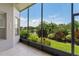 The screened-in porch offers views of the backyard with lush landscaping and pond at 3419 Fernwood Dr, Kissimmee, FL 34741