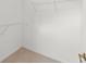A walk-in closet with white walls and shelving for organized storage at 3419 Fernwood Dr, Kissimmee, FL 34741