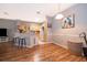 Dining area with hardwood floors, decorative painting, and view into kitchen at 3707 Conroy Rd # 1715, Orlando, FL 32839