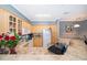 Kitchen featuring white appliances, light wood cabinetry, granite countertops and breakfast bar with view of sink at 3707 Conroy Rd # 1715, Orlando, FL 32839