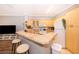 Kitchen with breakfast bar, tile floors, white appliances, and ample cabinetry at 3707 Conroy Rd # 1715, Orlando, FL 32839