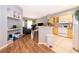 Bright kitchen with wood floors and breakfast bar adjacent to living area with view of modern appliances at 3707 Conroy Rd # 1715, Orlando, FL 32839