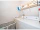 Laundry room featuring white washer and dryer units, shelving for storage, and laundry basket at 3707 Conroy Rd # 1715, Orlando, FL 32839
